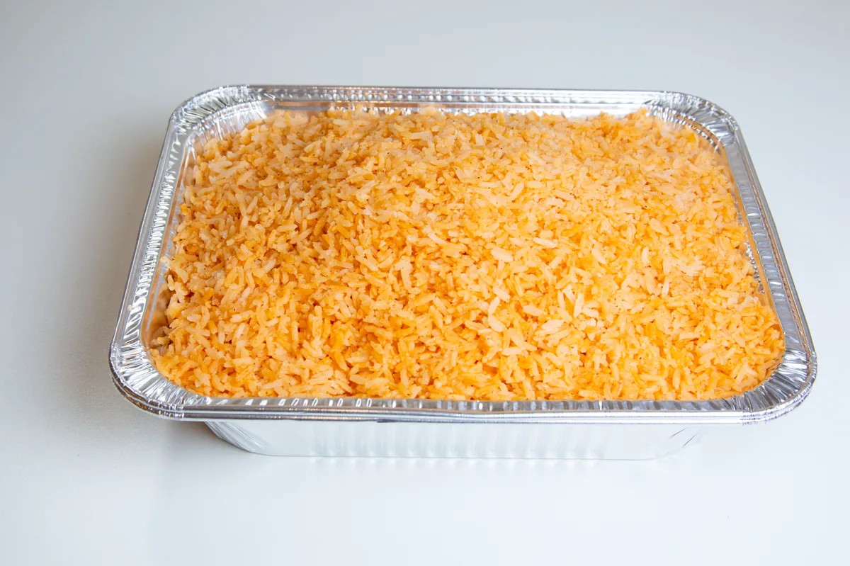 Tray of Mexican rice for a Viva Mexico Carnitas catering order