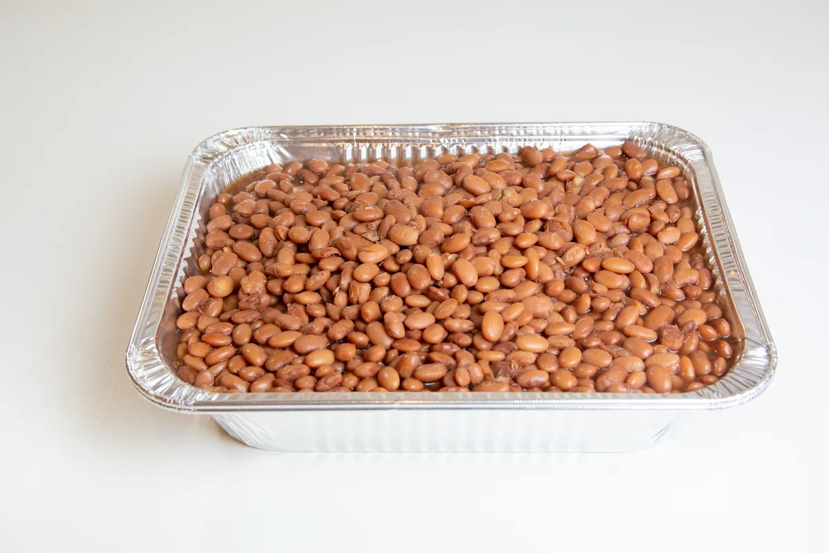 Tray of beans for a Viva Mexico Carnitas catering order