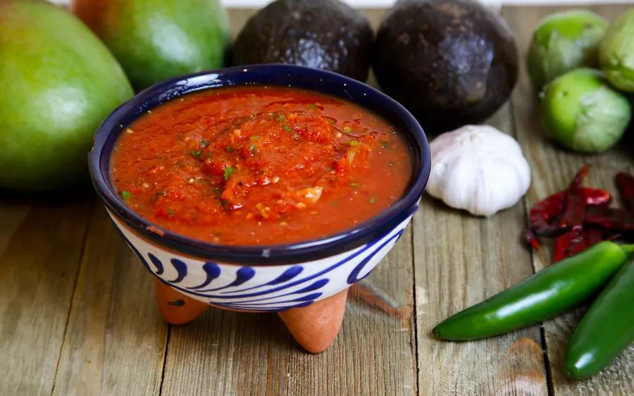 Fresh red salsa served in a traditional molcajete-style bowl
