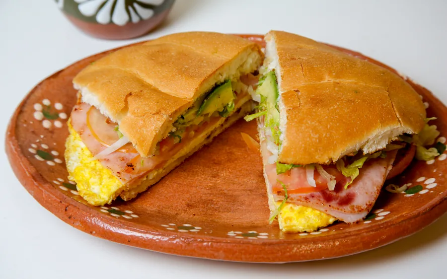 Ham torta with egg, avocado, lettuce, and tomato