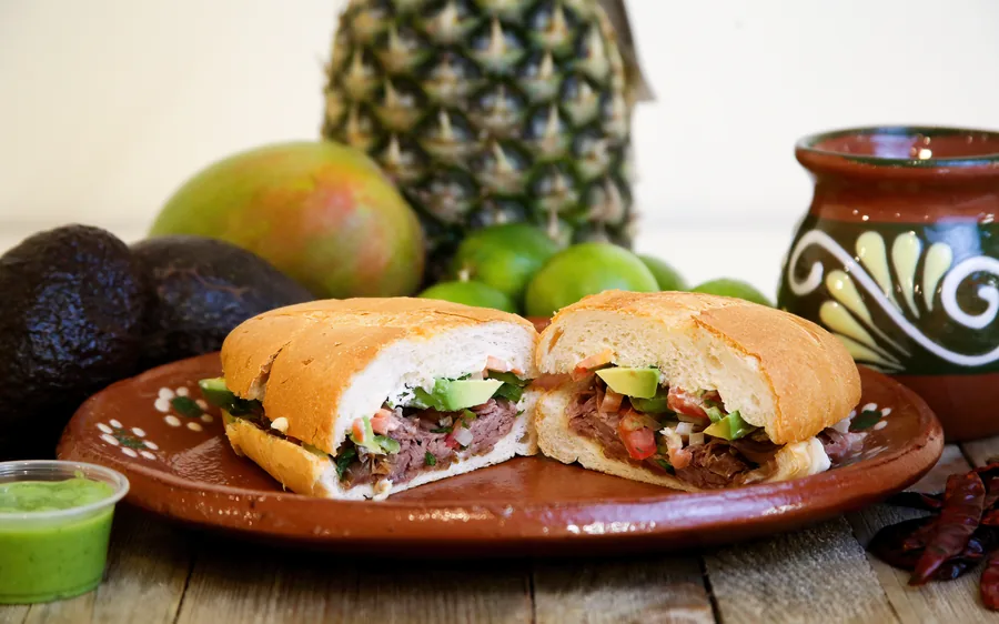 Torta Mexa with carnitas, pico de gallo, and avocado