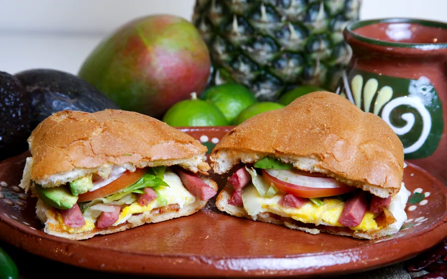 Sausage torta with egg, onion, tomato, and avocado
